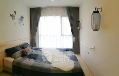 Cozy bedroom with modern decor and large window for natural light