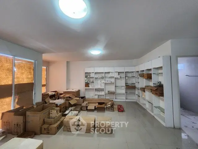 Spacious storage room with boxes and shelves, ideal for organizing and storing items efficiently.