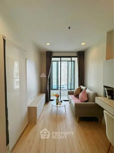 Modern living room with cozy sofa and large window in high-rise apartment