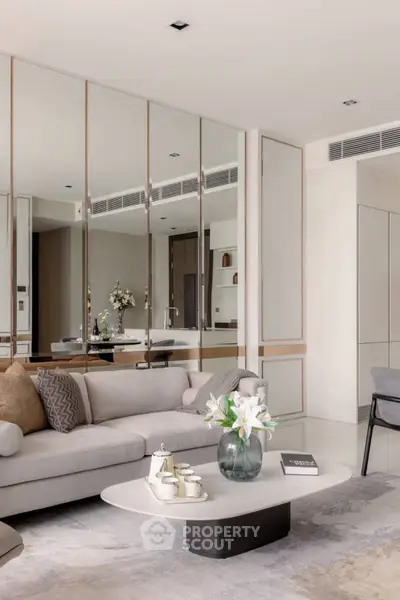 Luxurious modern living room with elegant decor and mirrored wall panels.