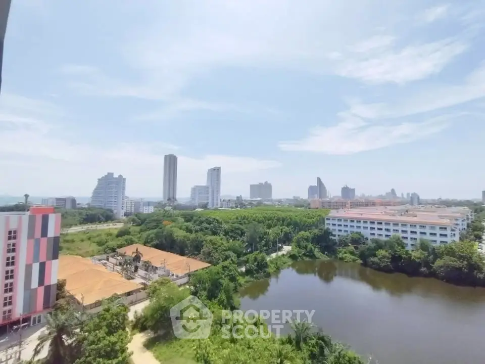 Stunning cityscape view with lush greenery and serene water body, perfect for urban living enthusiasts.