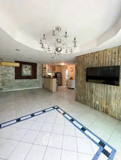 Spacious living room with modern chandelier and open kitchen layout