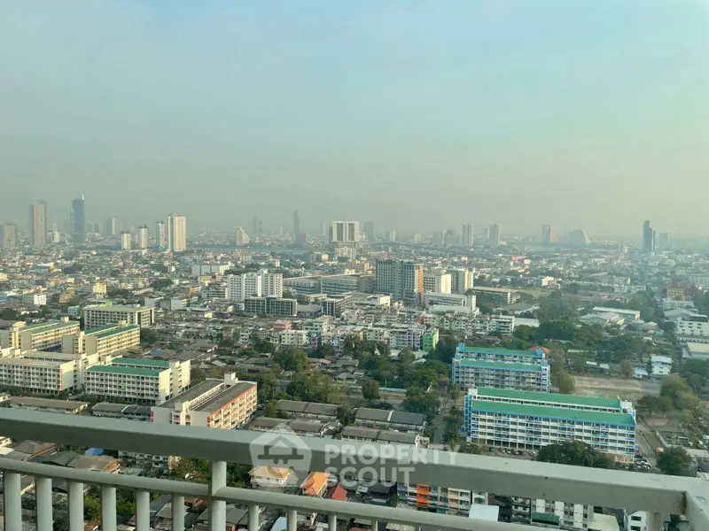 Stunning cityscape view from high-rise balcony showcasing urban skyline and vibrant city life.