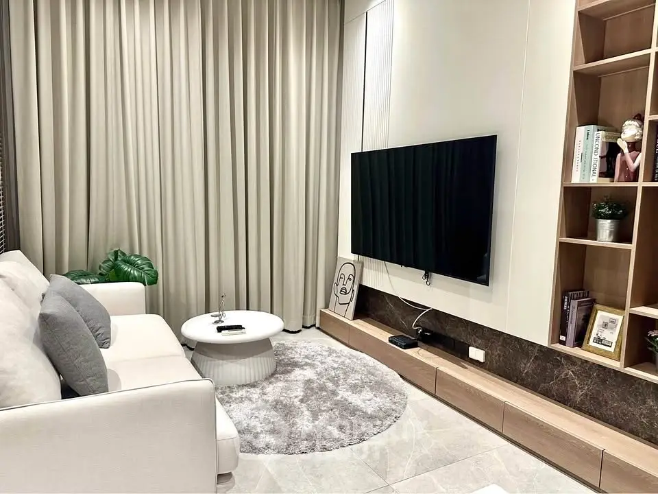 Modern living room with sleek TV setup and cozy seating area