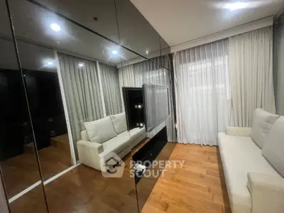 Modern living room with mirrored walls and cozy seating area