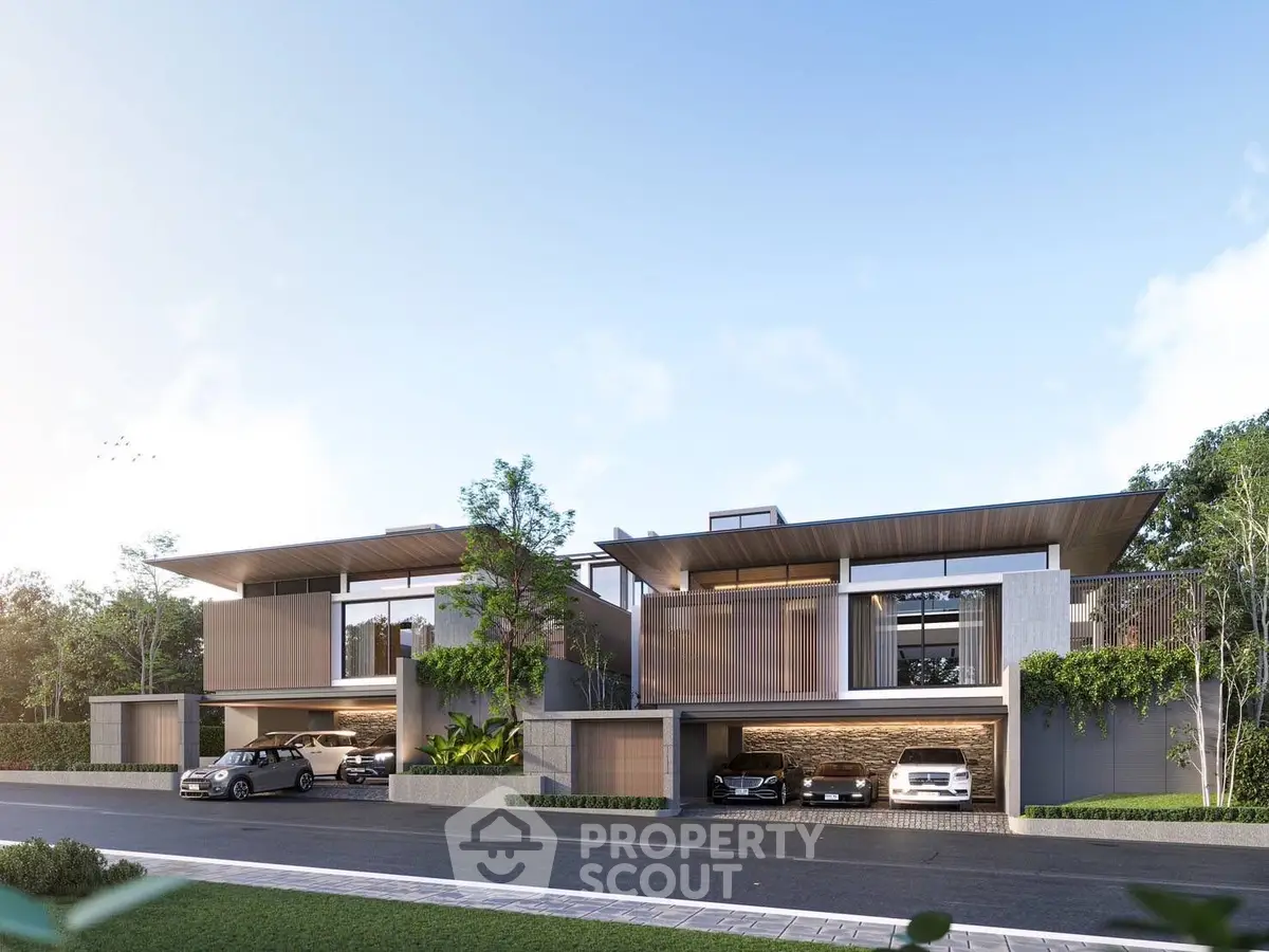 Modern luxury homes with sleek design and spacious garages in a serene neighborhood.