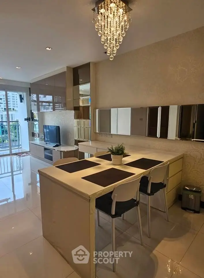 Modern living room with elegant chandelier and balcony view in upscale apartment