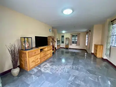 Spacious living room with modern decor and large windows for natural light.