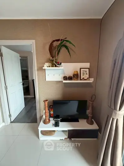 Cozy living room with modern decor and TV setup, perfect for relaxation.