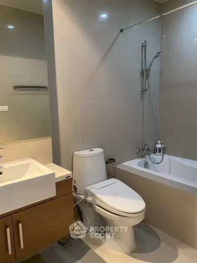 Modern bathroom with sleek fixtures and bathtub in contemporary apartment.