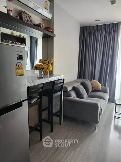 Modern living room with sleek furniture and stylish decor, featuring a cozy sofa and elegant dining area.
