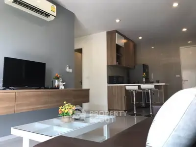 Modern living room with sleek furniture and open kitchen layout, perfect for stylish urban living.