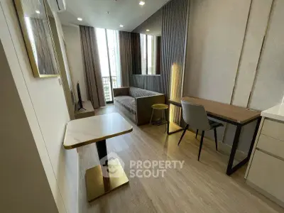 Modern living room with stylish decor and natural light in a high-rise apartment.
