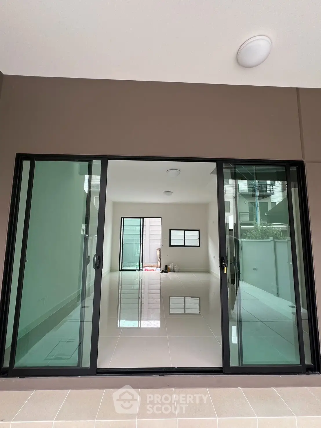 Modern interior with sliding glass doors and sleek tile flooring, perfect for natural light.