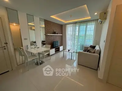 Modern living room with sleek design, featuring a cozy sofa, dining area, and large windows for natural light.