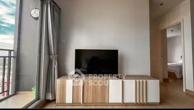 Modern living room with sleek TV stand and balcony view