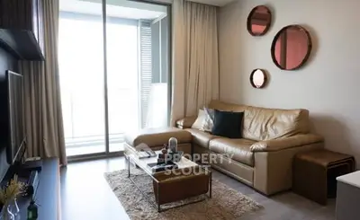 Stylish living room with leather sofa and modern decor, featuring a cozy ambiance.