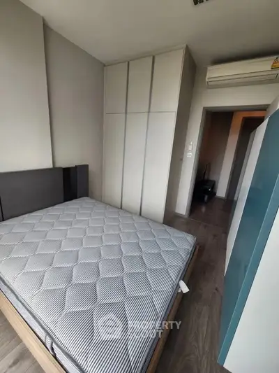 Modern bedroom with sleek wardrobe and air conditioning unit