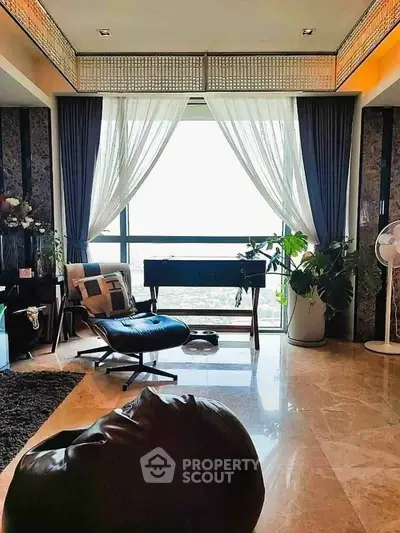 Luxurious living room with elegant decor and large window view.