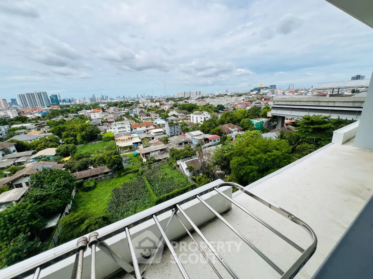 Stunning cityscape view from a spacious balcony in a modern high-rise apartment.