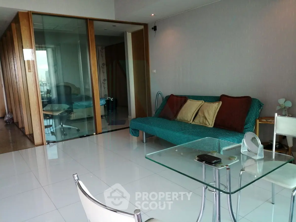 Spacious modern living room with glass partition and stylish furniture