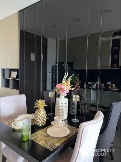 Stylish dining area with elegant table setting and modern decor in a contemporary apartment.