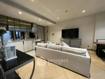 Modern open-plan living room with sleek kitchen and stylish decor