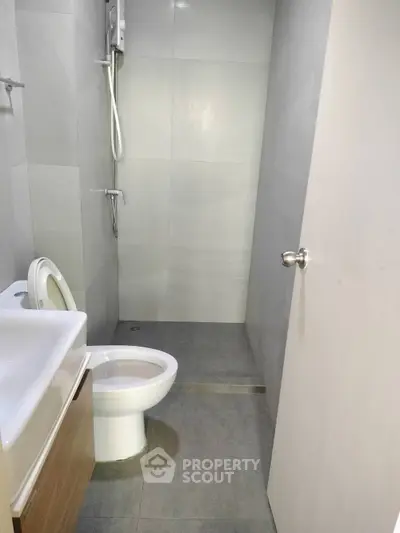 Modern minimalist bathroom with sleek fixtures and neutral tones.