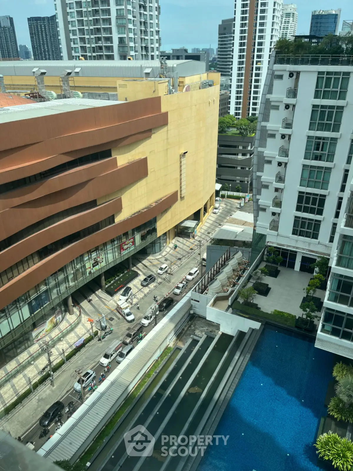 Stunning urban view with modern buildings and a luxurious pool in a vibrant cityscape.