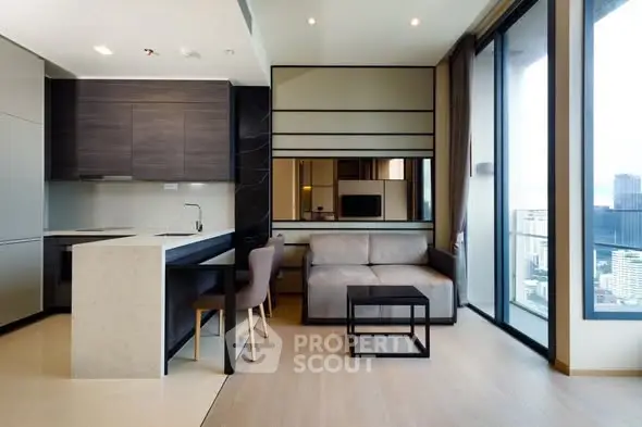 Modern open-layout living room with kitchen and city view balcony in luxury apartment.