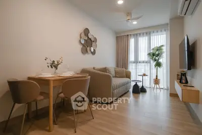 Modern living room with cozy seating and dining area, featuring elegant decor and natural light.