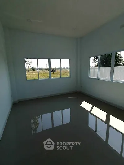 Spacious empty room with large windows offering natural light and scenic views, perfect for customization.
