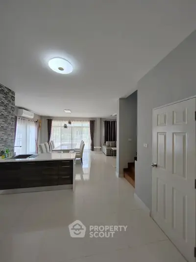 Spacious modern living room with elegant dining area and natural light