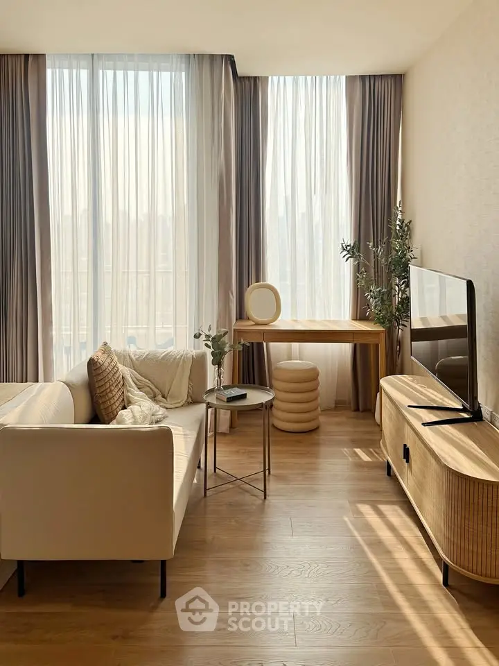 Elegant living room with modern furniture, large windows, and abundant natural light.