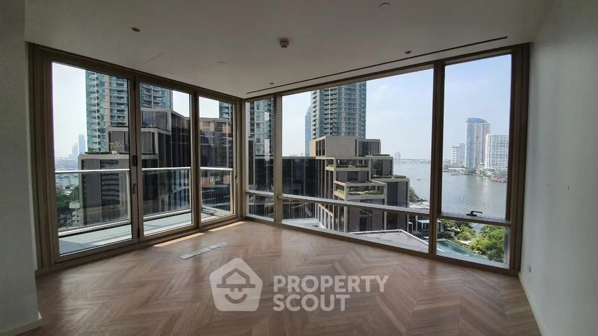 Spacious corner unit with stunning city and river views, featuring floor-to-ceiling windows and elegant wood flooring.
