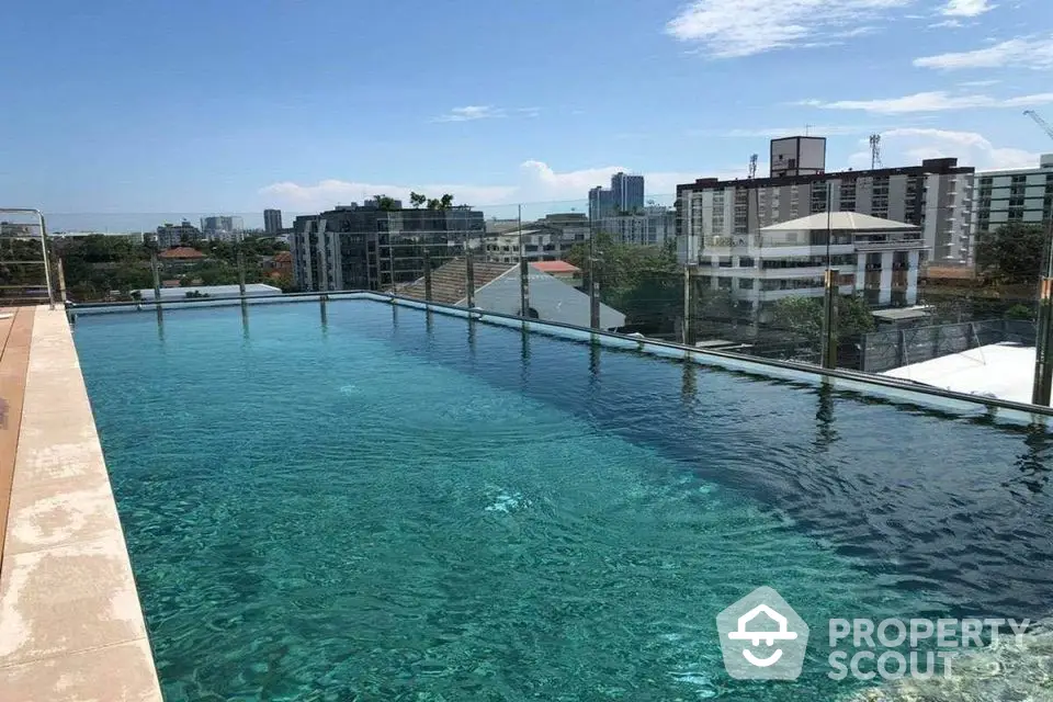 Stunning rooftop pool with city skyline views in a modern urban setting.