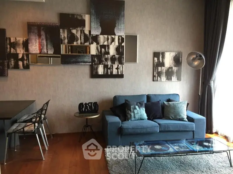 Stylish living room with modern decor and cozy seating area, perfect for relaxation and entertaining.