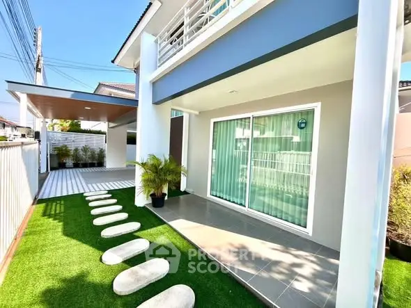 Modern house exterior with landscaped garden and stylish patio area.