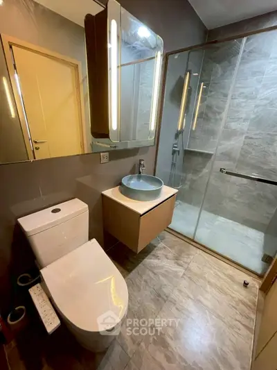 Modern bathroom with sleek fixtures and glass shower enclosure