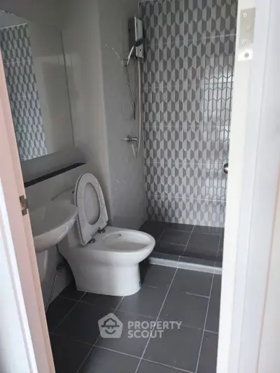 Modern bathroom with sleek shower and geometric tile design