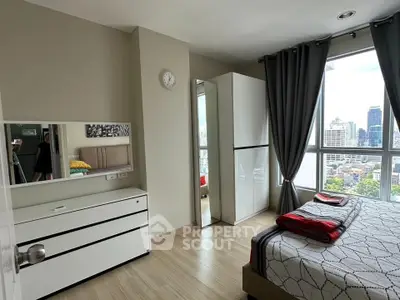 Modern bedroom with city view, featuring sleek furniture and large windows for natural light.
