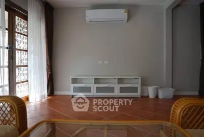 Spacious living room with air conditioning and elegant tile flooring