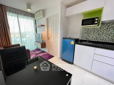 Modern studio apartment with kitchenette and city view, featuring sleek furniture and vibrant decor.
