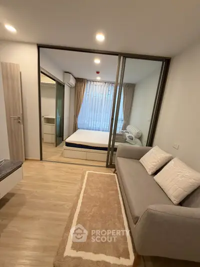 Modern apartment interior with cozy living room and bedroom, featuring elegant decor and natural light.