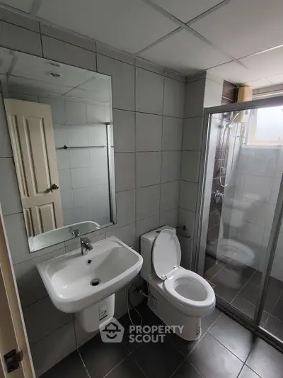 Modern bathroom with sleek fixtures and glass shower enclosure