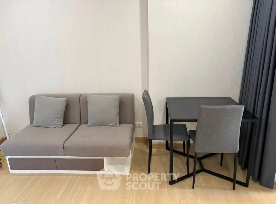 Modern living room with stylish sofa and dining table in a cozy apartment.