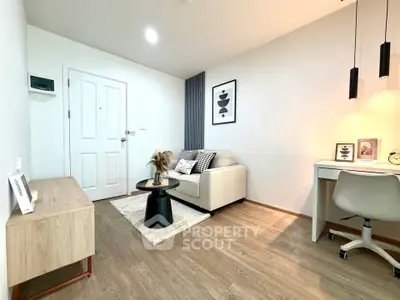 Modern living room with cozy sofa, stylish decor, and workspace in a bright apartment.