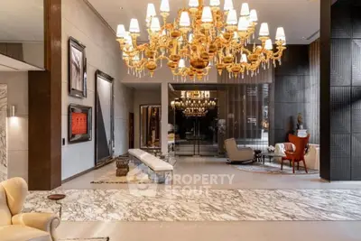 Luxurious lobby with elegant chandelier and marble flooring