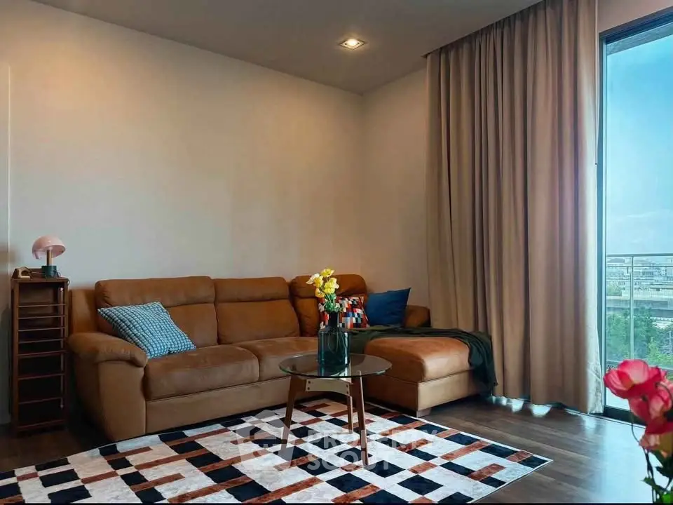 Modern living room with stylish decor and large window offering city view