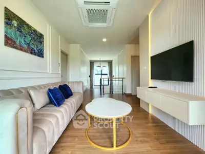 Modern living room with elegant decor and wall-mounted TV